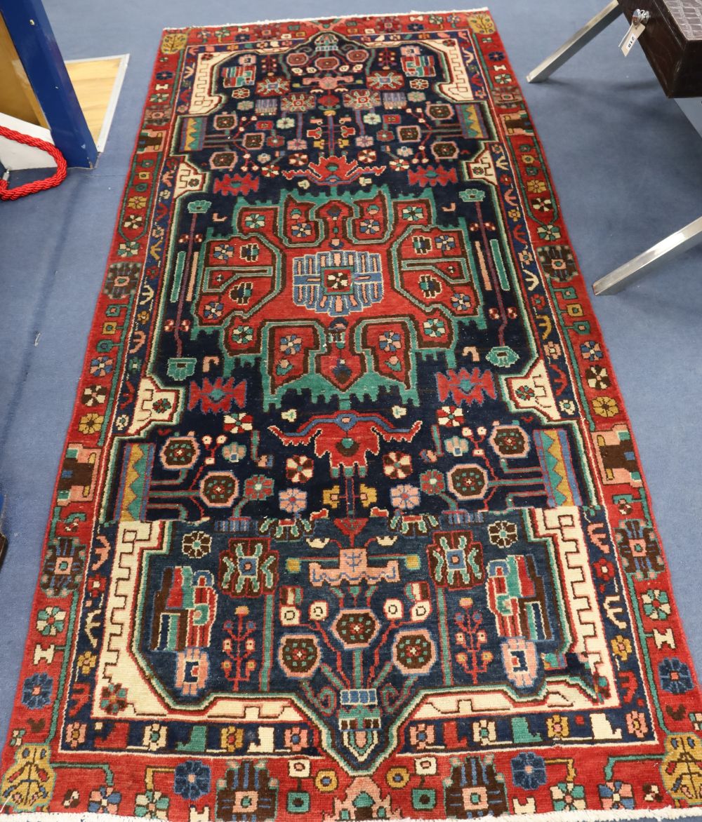 A Persian red ground rug, 282 x 134cm